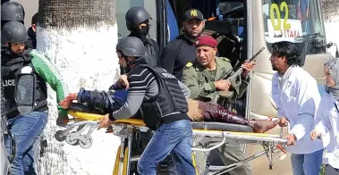  ?? PICTURE: AP ?? BLOODY ATTACK: A victim is evacuated by rescue workers outside the Bardo museum in Tunis, Tunisia yesterday. Gunmen opened fire at the leading museum in the capital, killing 17 foreign tourists and two Tunisians. A later raid by security forces left...