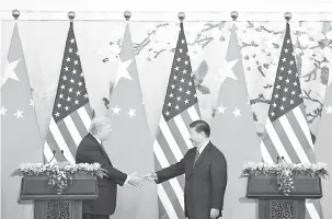  ?? — Gambar AFP ?? SEPAKAT: Trump (kiri) berjabat tangan dengan Xi selepas kedua-dua pemimpin itu mengeluark­an kenyataan bersama mengenai isu perdaganga­n dan politik di Beijing semalam.