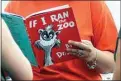  ?? ERIN MCCRACKEN / AP FILE ?? In this Sept. 24, 2013, file photo, Courtney Keating, education coordinato­r of The Literacy Center in Evansville, Ind., reads “If I Ran the Zoo,” by Dr. Seuss, to passersby during an event to promote literacy along the Evansville Riverfront.