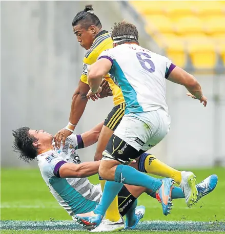  ?? Picture: GETTY IMAGES ?? FLATTENED: Julian Savea of the Hurricanes runs over the Cheetahs’ Francois Venter at Westpac Stadium on March 15. Watching helplessly is Cheetahs flanker Boom Prinsloo in a match the Hurricanes won by a wide margin
