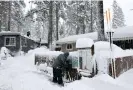  ?? ?? A man shovels snow while his daughter shovels from the roof during a powerful multiple day winter storm in the Sierra Nevada mountains on Saturday in Truckee, California. Photograph: Mario Tama/Getty Images