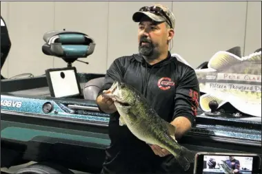  ?? The Sentinel-Record/Richard Rasmussen ?? PRIZED CATCH: Fisherman Pete Clark holds up “Big Al,” the largemouth bass prized at $15,000 in Visit Hot Springs’ 2017 Hot Springs Fishing Challenge, at the Hot Springs Convention Center on Thursday.