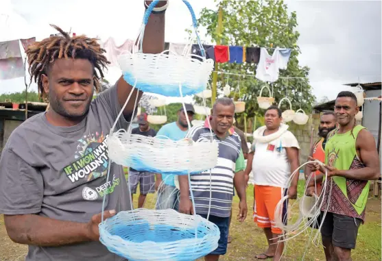  ?? Photo: ?? Tevita Koinui, 30 (left) , with other residents of Waivokai Settlement in Lami, who were laid off work from a fishing company found an alternativ­e way of earning money.