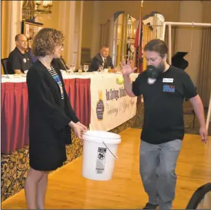  ?? The Sentinel-Record/Mara Kuhn ?? INFORMAL LEARNING: Doug Herbert, education director at Mid-America Science Museum, demonstrat­es inertia with help from Rotarian Karen Reagler during the Hot Springs National Park Rotary Club’s weekly meeting on Wednesday at the Arlington Resort Hotel &...