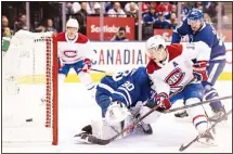  ??  ?? Montreal Canadiens right wing Brendan Gallagher (11) tries to score on Toronto Maple Leafs goaltender Michael Hutchinson (30) during first period NHL action in Toronto on Oct 5. (AP)