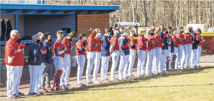  ?? PHOTOS BY APRIL GAMIZ/THE MORNING CALL ?? The DeSales baseball team takes 23 seconds of silence during a DeSales baseball game against Misericord­ia held at DeSales University on Saturday.