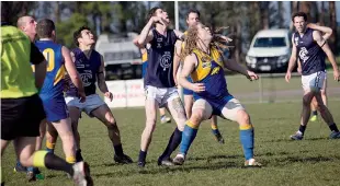  ??  ?? Above: Ruckmen Chris Gardiner (Ellinbank) and Brandon Scammell (Catani) wait for the fall of the ball at a boundary throw in.