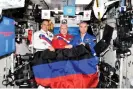  ?? Photograph: Roscosmos ?? The cosmonauts with the flag of the self-proclaimed Donetsk People’s Republic.