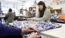  ??  ?? Writer Tara Deschamps was surprised to learn how easy weaving a bed was after taking part in the process at Sir William Osler High School.