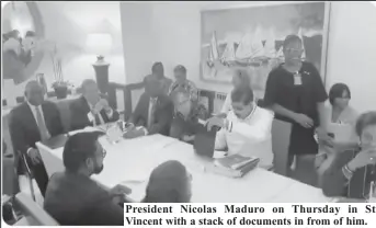  ?? ?? President Nicolas Maduro on Thursday in St Vincent with a stack of documents in from of him.
