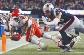  ?? The Associated Press ?? Kansas City Chiefs running back Kareem Hunt (27) crosses the goal line for a touchdown past New England Patriots safety Duron Harmon and linebacker Kyle Van Noy during the second half of their season-opening NFL game on Thursday in Foxborough, Mass.