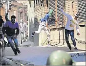  ?? AFP PHOTO ?? Protesters clash with policemen in Srinagar on Sunday following gunfights between militants and security personnel.
