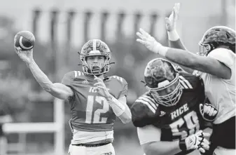  ?? Michael Wyke / Contributo­r ?? Redshirt freshman quarterbac­k Luke McCaffrey, left, made use of his reps under center, putting his play-making ability on display, particular­ly with his legs, during Rice’s first scrimmage.