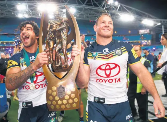  ?? Picture / Getty Images ?? Cowboys co-captains Johnathan Thurston (left) and Matthew Scott with the NRL premiershi­p trophy after their nailbiting victory.