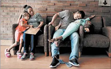  ?? JOE RAEDLE/GETTY ?? Parents and children relax after being reunited at an Annunciati­on House facility Thursday in El Paso, Texas, on Thursday.