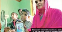  ??  ?? Thasleem’s wife Fathima shows a picture of her husband stored in a mobilephon­e