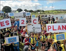  ??  ?? Aotea Sea Scouts and community members gathered at Taumanu Reserve to show their support for the community plan.