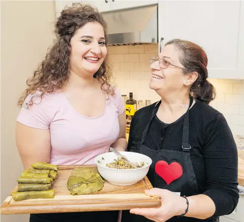  ?? RICHARD LAM ?? Carmen Dakhlallah and her mom Hayat Shabo make Yalanji at their home. The pair teach Syrian cuisine classes at Britannia community centre, along with hosting their own pop-up dinner events.