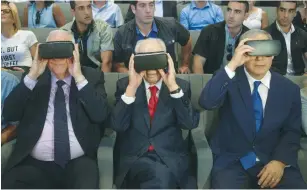  ?? (Reuters) ?? PRESIDENT REUVEN RIVLIN, former president Shimon Peres, and Prime Minister Benjamin Netanyahu don virtual reality goggles at the Peres Center for Peace and Innovation in Jaffa yesterday.