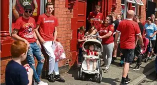  ?? — AFP ?? Please be safe: Fans are seen celebratin­g on the streets opposite anfield.