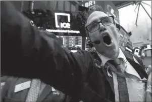  ?? The Associated Press ?? STOCKS: Trader Gregory Rowe works on the floor of the New York Stock Exchange on Tuesday. Stocks are opening sharply lower on Wall Street following big drops in Asia and Europe.