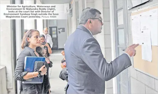  ?? Picture: RAMA ?? Minister for Agricultur­e, Waterways and Environmen­t Dr Mahendra Reddy (right), looks at the court list with Director of Environmen­t Sandeep Singh outside the Suva Magistrate­s Court yesterday.