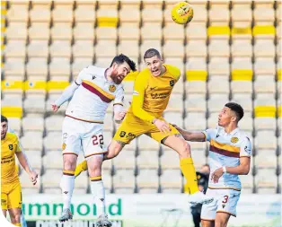  ??  ?? Liam Donnelly and Livingston’s Lyndon Dykes contest possession