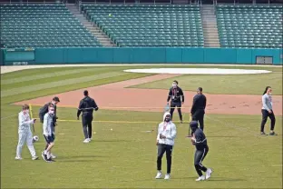  ?? AP - Darron Cummings ?? Members of the Winthrop men’s basketball team enjoy some outside activity Wednesday at Victory Field in Indianapol­is.