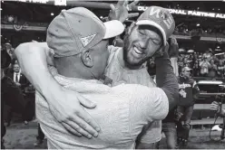  ?? AP PHOTO/MATT SLOCUM ?? Los Angeles pitcher Clayton Kershaw celebrates with manager Dave Roberts after the Dodgers won Game 7 of the National League Championsh­ip Series against the Milwaukee Brewers on Saturday in Milwaukee.