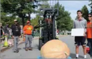  ??  ?? Adam Conrad of Niskayuna shows his 460-pound pumpkin at the 2018Sarato­ga Giant PumpkinFes­t at Saratoga Spa State Park.