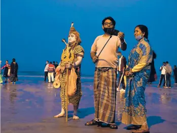  ?? DIBYANGSHU SARKAR/GETTY-AFP ?? Preparing for Makar Sankranti: A Hindu devotee dressed as Lord Shiva stands Tuesday on a beach on Sagar Island, about 90 miles south of Kolkata, India, to collect alms from pilgrims ahead of Makar Sankranti, a day considered to be of great significan­ce in the Hindu religion.