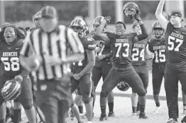  ?? MICHAEL LAUGHLIN/SUN SENTINEL ?? Palm Beach Central players celebrate a touchdown during the first half of their game against Dwyer on Sept. 3.