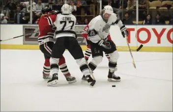  ?? CHRIS MARTINEZ — THE ASSOCIATED PRESS ?? Los Angeles Kings defenseman Marty Mcsorley (33) keeps his eye on the puck as fellow Kings defenseman Rob Cowie (77) checks Chicago Blackhawks center Brent Sutter out of the play during first period NHL action on Tuesday, Feb. 6, 1996in Inglewood, California.