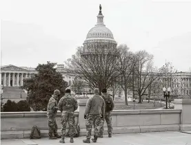  ?? Patrick Semansky / Associated Press ?? Members of the military stand on the steps of the Library of Congress’ Thomas Jefferson Building on Friday, two days after the attack on the Capitol.