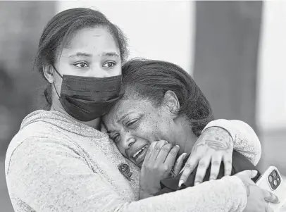  ?? Melissa Phillip / Staff photograph­er ?? Shellie Calhoun, left, comforts Shanette Lewis on Thursday. Lewis’ son, Charion Lockett, was shot and killed Monday by Houston police at the family’s home. Police say he fired on undercover officers first.