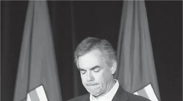  ?? LEAH HENNEL / CALGARY HERALD ?? Alberta PC Leader Jim Prentice resigns his seat before a subdued crowd at the provincial party headquarte­rs in Calgary on Tuesday evening.