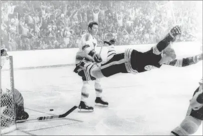  ??  ?? The Associated Press file In this May 10, 1970, photo shot by Ray Lussier of The Boston Herald and reprinted by The Associated Press, Bruins defenseman Bobby Orr goes horizontal into the air after scoring the goal against the St. Louis Blues that won...
