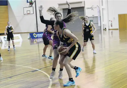  ?? PHOTO: LINDA ROBERTSON ?? Keeping cool . . . Ajax player Danielle Frost (front) takes on Claudia Flaws, of the South Pacific Magic, in the Dunedin women’s premier basketball final at the Edgar Centre last night,