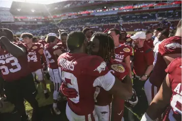  ?? NWA Democrat-Gazette/Charlie Kaijo ?? Arkansas wide receiver Tyson Morris (19) and wide receiver Trey Knox (7) embrace Saturday after Arkansas’ 24-10 win over Penn State in the Outback Bowl at Raymond James Stadium in Tampa, Fla.