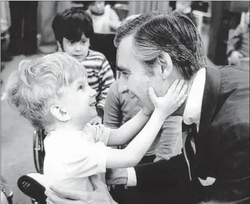  ?? Jim Judkis ?? FRED ROGERS meets with a disabled boy in a scene from hit documentar­y “Won’t You Be My Neighbor?”