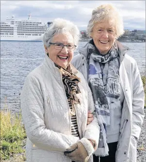  ?? DAVID JALA/CAPE BRETON POST ?? Jean Knight, 91, left and traveling companion Cynthia Skae, 83, were all smiles after getting an unexpected tour of the Sydney area after arriving in Cape Breton aboard the Silver Spirit cruise ship that is visible in the background. The veteran world travelers said they loved their short visit to the area with one amazed by the number of wooden houses and the other struck by the amount of undevelope­d and wide-open spaces.