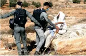  ?? Reuters ?? A Palestinia­n scuffles with Israeli border police officers as Israeli machinery demolishes a Palestinia­n house in the Israeli-occupied West Bank.