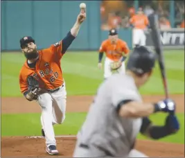  ?? The Associated Press ?? Houston Astros starting pitcher Dallas Keuchel delivers during the first inning of Game 1 against the New York Yankees in the American League Championsh­ip Series on Friday in Houston.The Astros won 2-1.