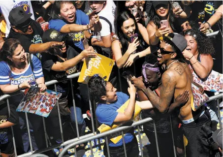  ?? Santiago Mejia / The Chronicle ?? Reserve guard Nick Young, better known as “Swaggy P,” greets fans during the Warriors’ championsh­ip parade in Oakland.