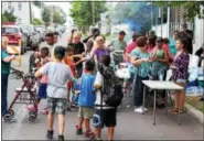  ??  ?? People walk along Washington Street in Pottstown for National Night Out Tuesday.