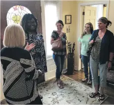  ??  ?? Rhonda Kelley, left, hosts female students for tea in the president’s home on the campus of New Orleans Baptist Theologica­l Seminary. “Our biblically assigned role is to submit to men,” she believes.