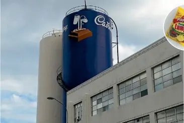  ?? PHOTOS: STUFF; MICHAEL BRADLEY ?? Left, the normal hustle and bustle of the factory floor has been replaced by silence at the Cadbury factory in Dunedin. Above, Oamaru-based Rainbow Confection­ery still makes Pineapple Chunks, under the Regina brand.