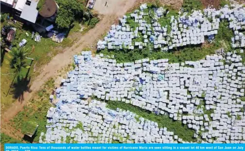  ??  ?? DORADO, Puerto Rico: Tens of thousands of water bottles meant for victims of Hurricane Maria are seen sitting in a vacant lot 40 km west of San Juan on July 28, 2019. — AFP