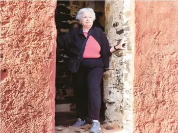  ?? STEFAN KLEINOWITZ/AP ?? Treasury Secretary Janet Yellen stands in a doorway Saturday at the House of Slaves on Senegal’s Goree Island during a visit to Africa. Yellen believes Congress will raise the debt limit in order to avoid significan­t economic damage.