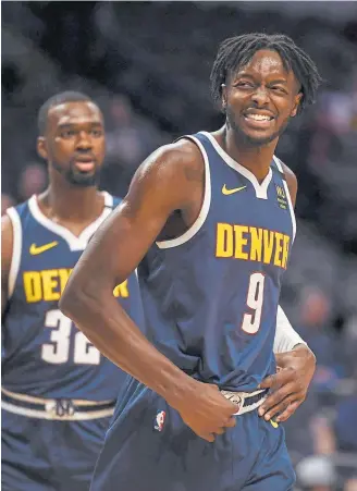  ??  ?? Jerami Grant of the Nuggets smiles after looking up with 15 seconds to play to see that he had scored 29 points against the Detroit Pistons on Tuesday.